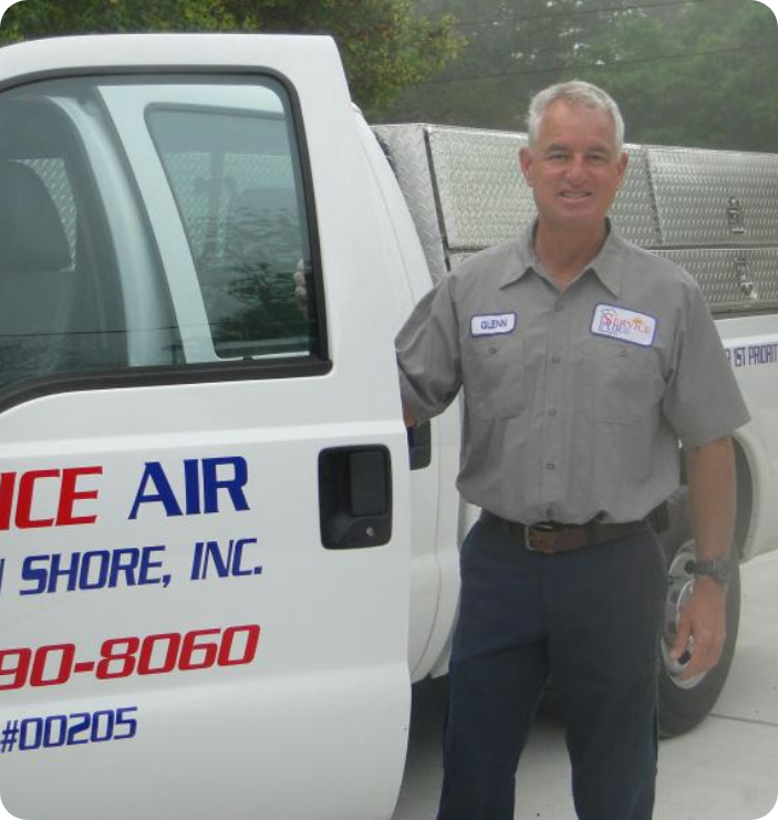 picture of a Service Air HVAC tech with gray hair standing by a Service Air service truck